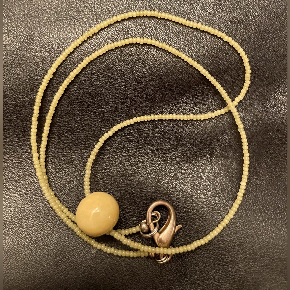 22” seed bead necklace with one large ceramic bead @ 1/2”.  Handcrafted